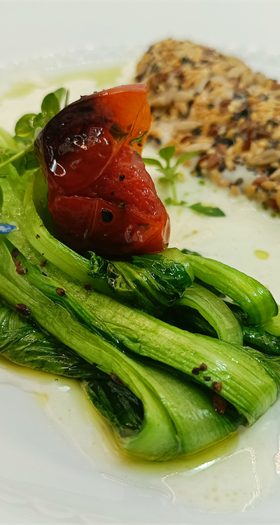 Filetto di branzino con semi tostati, pak choi alla piastra  e salsa al vino bianco